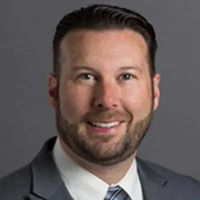 a portrait of Jeremy Hixson wearing a gray suit