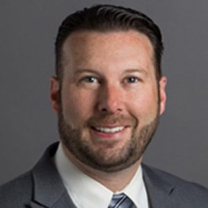 a portrait of Jeremy Hixson wearing a gray suit